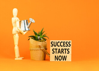 Success starts now symbol. Concept word Success starts now on beautiful wooden block. Businessman...