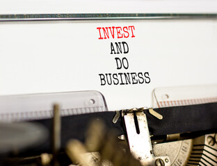 Invest and do business symbol. Concept word Invest and do business typed on beautiful old retro typewriter. Beautiful white paper background. Invest and do business concept. Copy space.