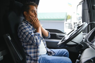 Portrait of tired indian truck driver feeling sleepy and sick.