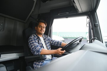 Portrait of a young handsome Indian truck driver. The concept of logistics and freight transportation.