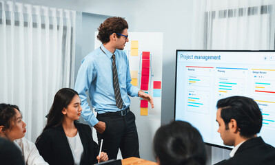 Project manager planning schedules for business task at meeting room, Gantt chart software show on...