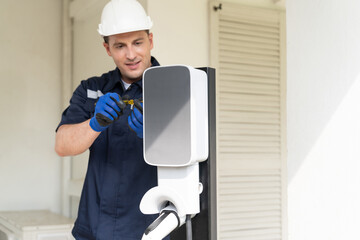Qualified technician install home EV charging station, providing maintenance service for electric...