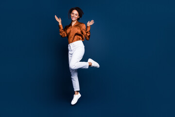 Full size photo of attractive young woman jumping wave hands wear trendy brown satin formalwear...