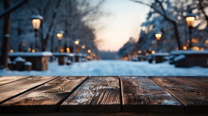 Obraz premium Winter xmas background with empty space on table top in front. Christmas horizontal blank scene. Wooden table top in front, blurred сhristmas tree in the snow. Snowy scene