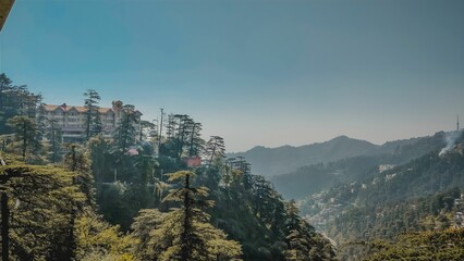 Blue sky over Shimla Himachal Pradesh Mountains, trees, and buildings