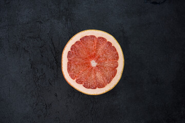 Bloody orange fruit on black background