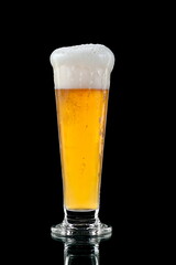 cold glass of refreshing beer on black background