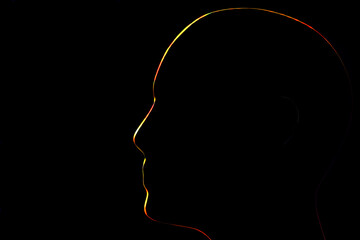 red and yellow shing contours of a human head