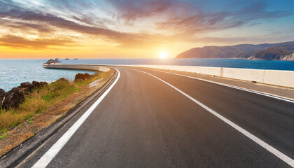 asphalt highway road at sunset by the sea