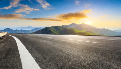 asphalt road and mountain range natural landscape at sunrise panoramic view - obrazy, fototapety, plakaty