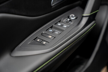 car window button panel on left doors with leather and plastic material