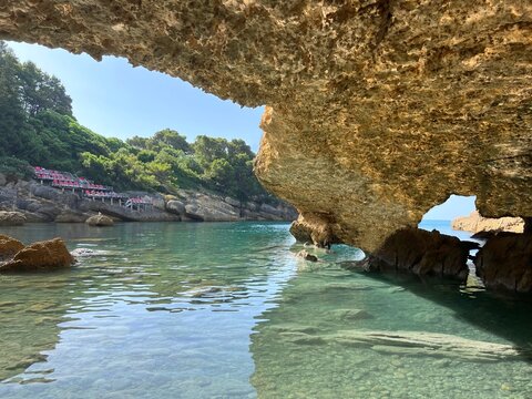 Sea clear water, pebbly secluded beach among coastal rocks in Montenegro.