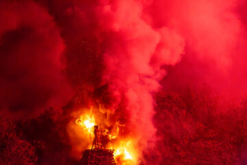 A burning bonfire with glowing smoke surrounding © lemanieh
