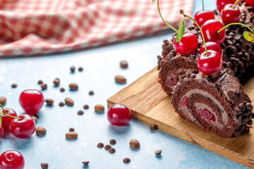 Chocolate roll cake with cream and cherries.