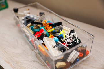 Children's colorful toys, tiny legs, and building blocks scattered on the floor, a playful scene of early childhood development