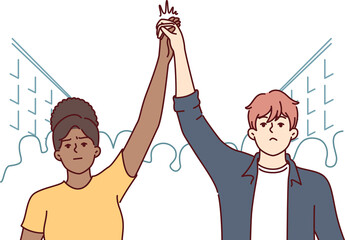 Protesting activists hold hands in solidarity, stand on street among crowd during revolution