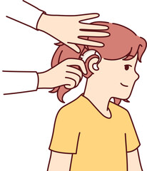 Doctor puts hearing aid on child ear to help girl cope with congenital problem that causes deafness