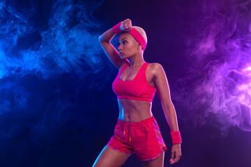 Sporty fit woman, athlete after fitness exercises on black background. Download cover for music collection for fitness classes. Sports recreation. Beautiful black young woman.