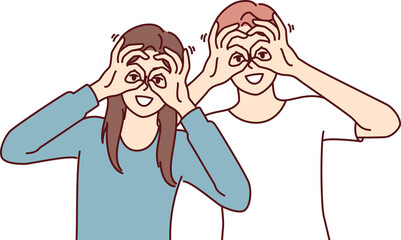 Funny man and woman make binoculars from fingers and look at screen smiling to cheer friends.