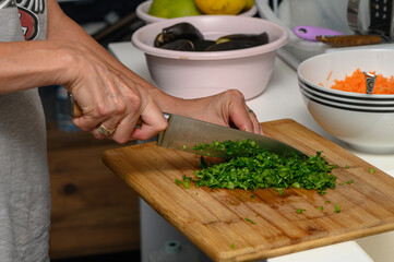 woman cutting parsley on a cutting board in the kitchen 6