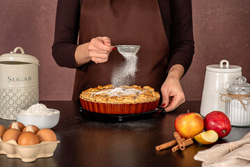 Food photography of apple pie cooking, american dessert; sugar powder, icing, pour, cinnamon; confectionery; bakery; baking; pastry