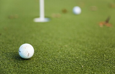 golf ball on the green, poised to sink into the hole, with the flag fluttering in the breeze, epitomizing precision and victory