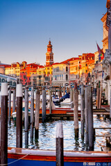 Grand canal with Rialto bridge in Venice at sunset, Italy. Looking along the Grand Canal in Venice back to the Rialto Bridge in Venice.  - obrazy, fototapety, plakaty