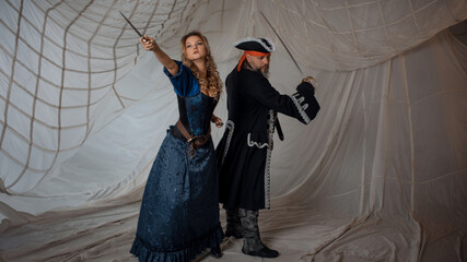A lady with a dagger and a pirate in an old doublet with a saber, a battle with enemies, a pirate...