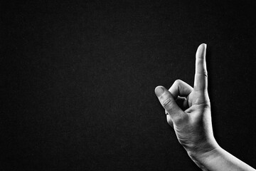 Hand Finger Pointing Sign in Black and White on Textured Paper Background, Copy Space