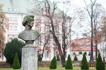 Closeup of the Chopin statue with a building blurred background on a gloomy day in Poznan, Poland
