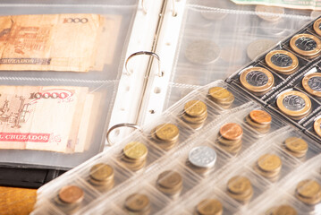 Money, collection of coins and Brazilian money notes, dark background, selective focus.