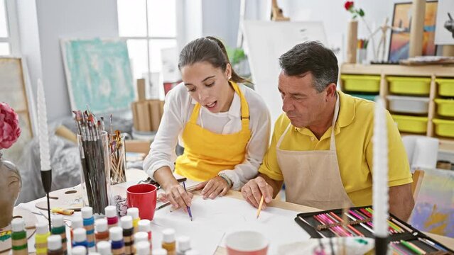 Inside a artistic haven, confident man and woman artists joyously drawing together in their art studio, smiling amidst canvas and paintbrushes