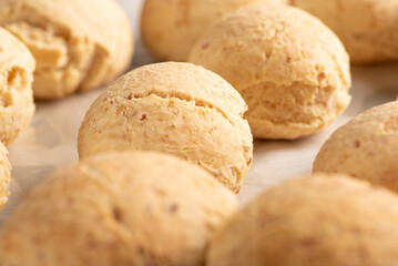 Cheese bread, shape with cheese bread arranged on rustic wood, dark background, selective focus.