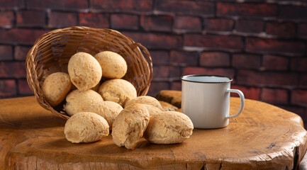 Cheese bread, basket with cheese bread arranged on rustic wood, dark background, selective focus.
