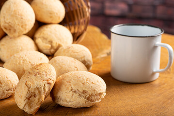 Cheese bread, basket with cheese bread arranged on rustic wood, dark background, selective focus.