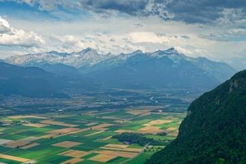 Aerial view of agricultural fields before the mountains in  Rhone Valley