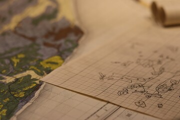 Closeup of old maps laid together on a table, a cartographic background