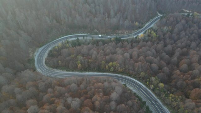 Curvy mountain roads in autumn. Vehicles in motion on winding mountain roads. 