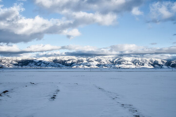 Fototapeta na wymiar Snowy mountain range on a cloudy day