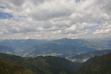 Beautiful landscape of big mountains of the Alps in Italy under the cloudy sky during the daytime