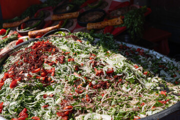 Large Onion Bowl of Fresh Turkish Salad with Sumac. Traditional Assortment of Turkish Greens and Vegetables Salad