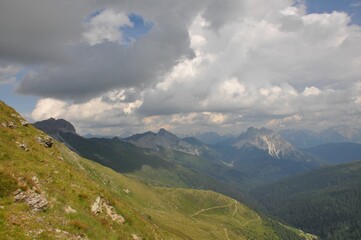 Beautiful landscape of big mountains of the Alps in Italy under the cloudy sky during the daytime