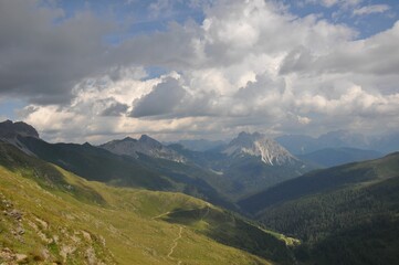 Fototapeta na wymiar Beautiful landscape of big mountains of the Alps in Italy under the cloudy sky during the daytime