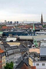 Vertical drone shot of buildings, the Church of the Savior and the Oresund Bridge in Copenhagen
