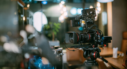 Professional cinema and video camera on the set. Shooting shift, lighting fixtures, shooting equipment and the team.