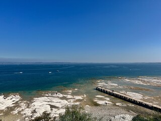 Rocca Scaligera Castle in Sirmione Lake Garda Italy. Aerial view. Popular travel destination on Lake Garda in Italy. Scaligero Castle drone view. Sirmione top view