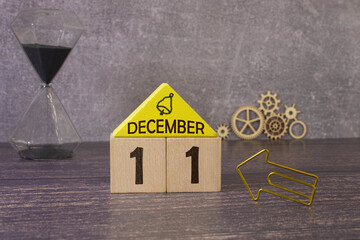December 11 text on wooden blocks with blurred nature background. Copy space and calendar concept