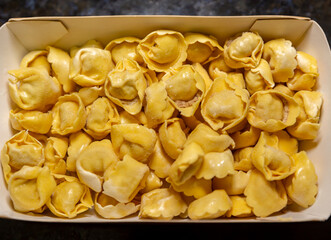 Traditional Italian tortellini (capeletti, agnolini) soup with chicken and vegetables, special soup for cold nights. Closeup