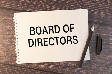 The words BOARD OF DIRECTORS is written in a white notepad near a white cup of coffee on a light background