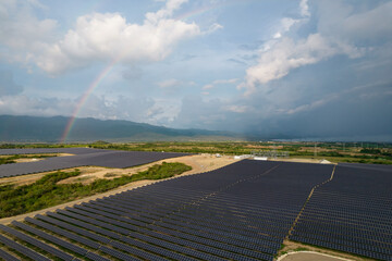 rainbow over solar farm field